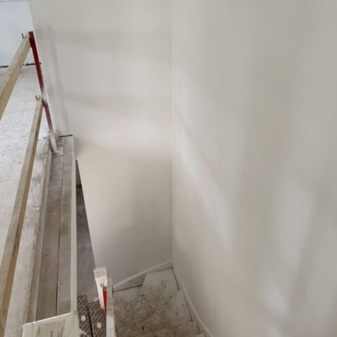 Mican completes dry lining plastering on the internal walls of a staircase at a Moss Nook new build home in St Helens, Merseyside